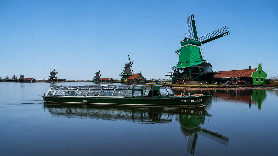 Tour boat on the water by the windmills of Zaanse Schans